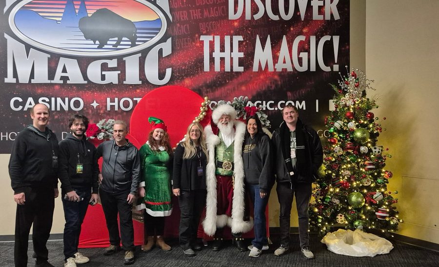 Santa with smiling staff at a corporate holiday event